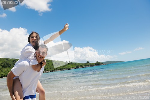 Image of happy couple have fun on the beach