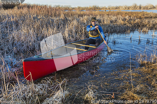 Image of canoe paddling through a swamp