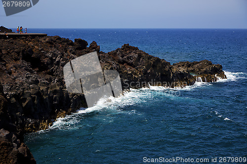 Image of people stone volcanic spain  water coast in lanzarote   