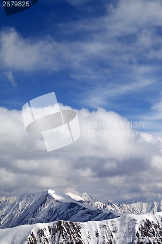 Image of Winter snowy mountains and sky with clouds at nice day