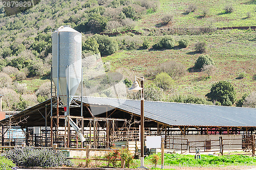 Image of Rustic cowshed with silo in the countryside