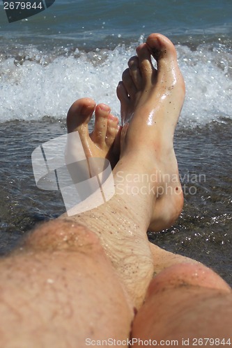 Image of my legs in blue sea 