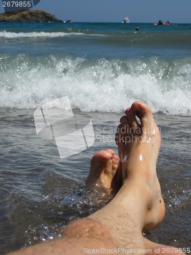 Image of my legs in blue sea 