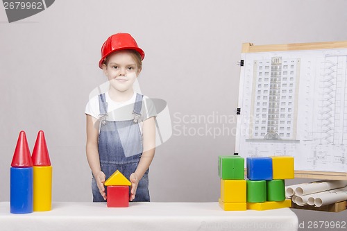 Image of The girl is building a house on drawing