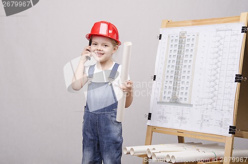 Image of Child drawing at Board, talking on phone