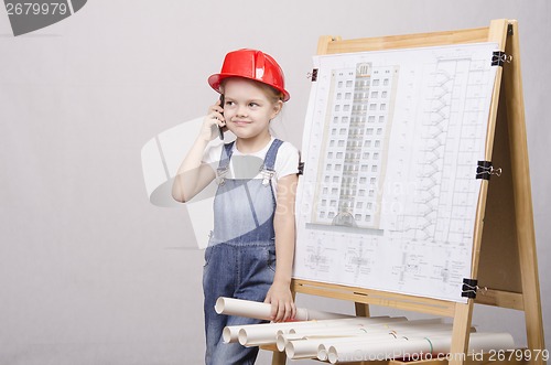 Image of The child in helmet talking on phone