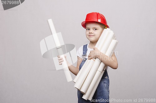 Image of Child architect holds a lot of drawings