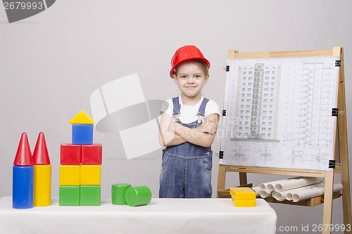 Image of Child Builder builds a house on the drawing