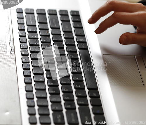 Image of Young woman working on laptop