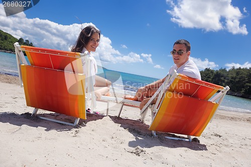 Image of happy couple have fun on the beach