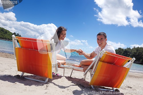 Image of happy couple have fun on the beach