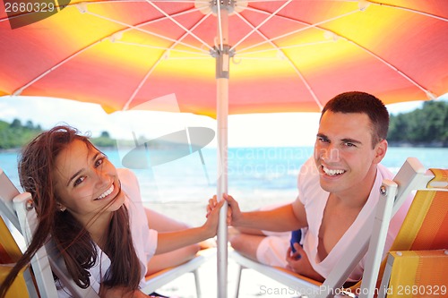 Image of happy couple have fun on the beach