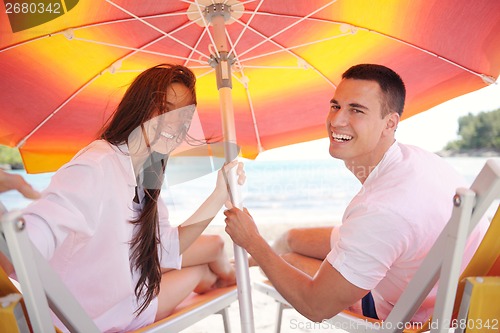 Image of happy couple have fun on the beach
