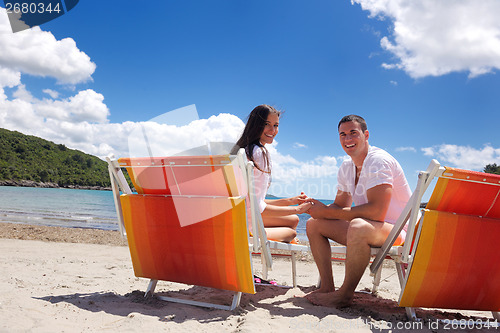 Image of happy couple have fun on the beach