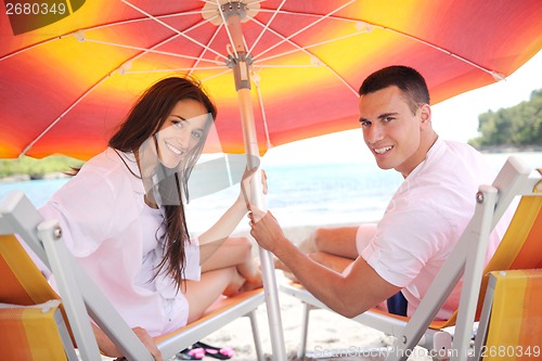 Image of happy couple have fun on the beach