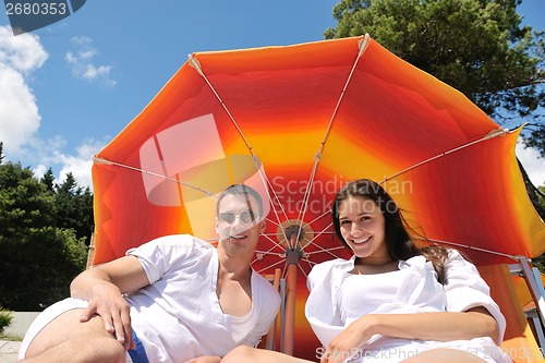 Image of happy couple have fun on the beach