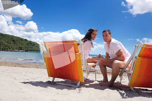 Image of happy couple have fun on the beach