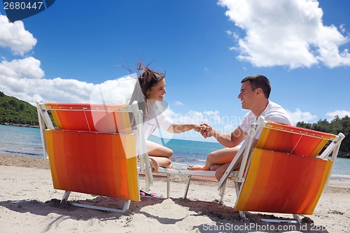 Image of happy couple have fun on the beach