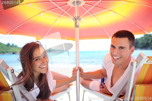 Image of happy couple have fun on the beach