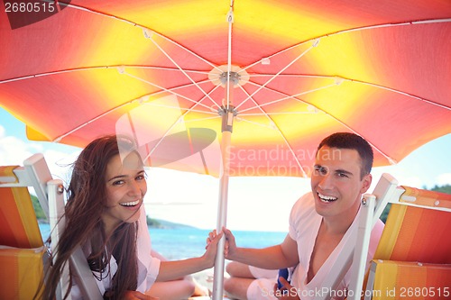 Image of happy couple have fun on the beach