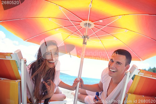 Image of happy couple have fun on the beach