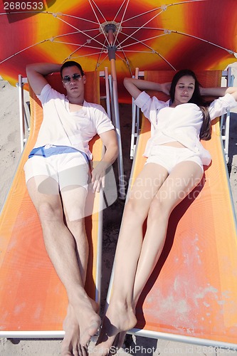 Image of happy couple have fun on the beach