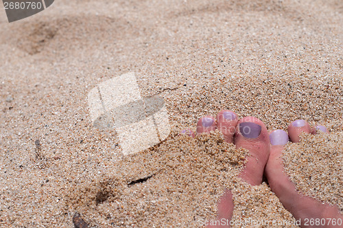 Image of Fingers with pedicure the beach