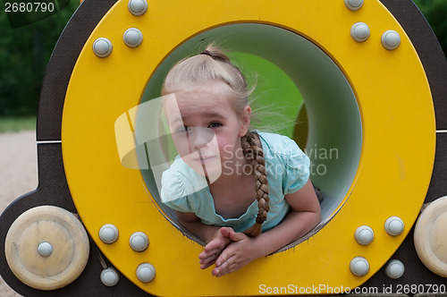 Image of Young girl sitting in crawl tube
