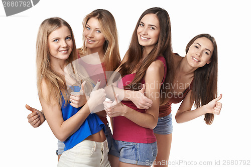 Image of Happy group of friends gesturing thumbs up