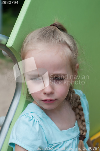 Image of Serious beautiful girl on the playground
