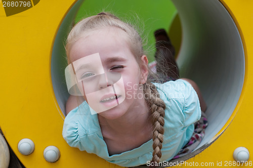 Image of Young girl lying in crawl tube