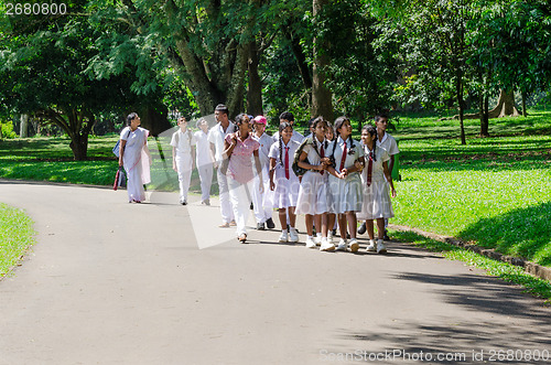 Image of group of pupils in a traditional school clothes on excursion in 