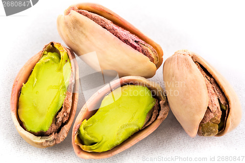 Image of A stack of roasted pistachios on white 
