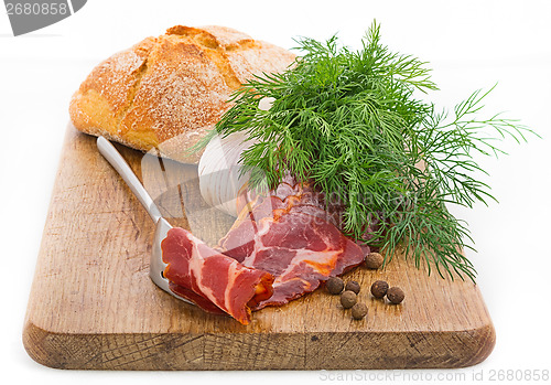 Image of Rustic still life with bacon, bread, garlic and herbs