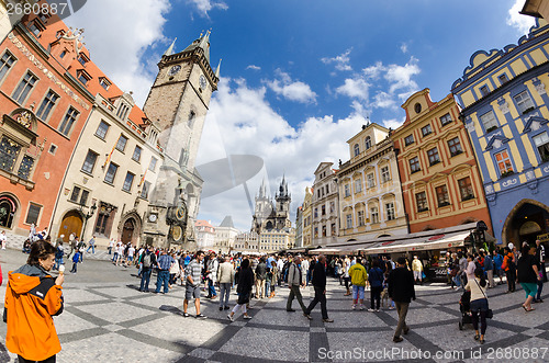 Image of Tourists walk around the Old Town Square in Prague waiting for s