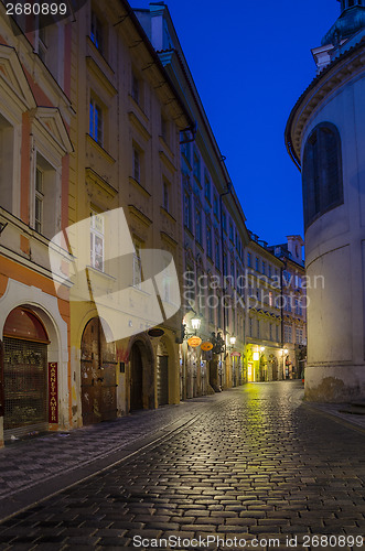 Image of narrow alley with lanterns in Prague at night
