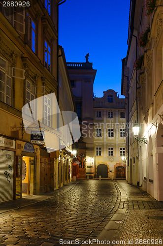 Image of narrow alley with lanterns in Prague at night