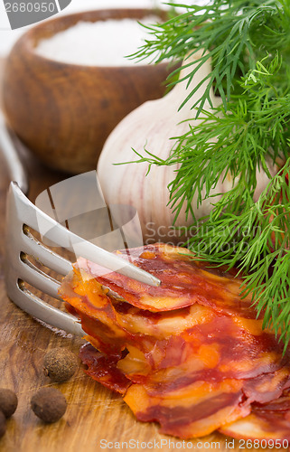 Image of rustic still life with a slice of sausage