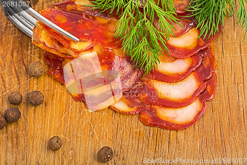 Image of rustic still life with a slice of sausage