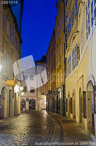 Image of narrow alley with lanterns in Prague at night