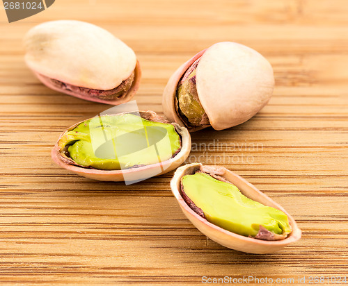 Image of A stack of roasted pistachios on wood