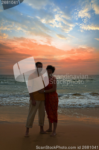 Image of couple on the beach at sunset