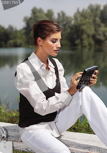 Image of a woman with laptop in park cvb