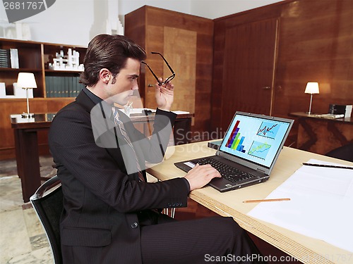 Image of businessman with laptop in office l