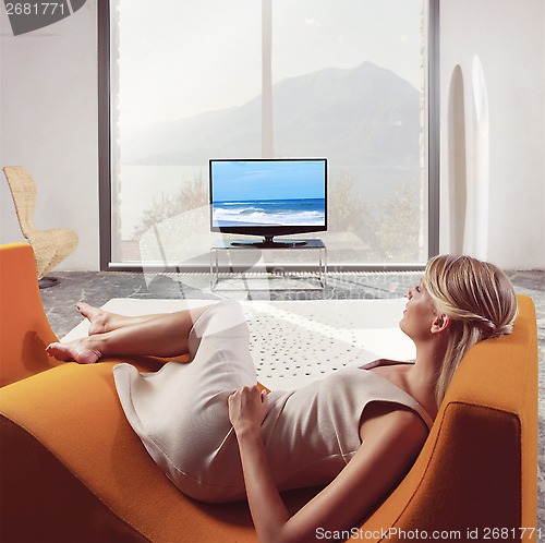 Image of woman relaxing and watching TV