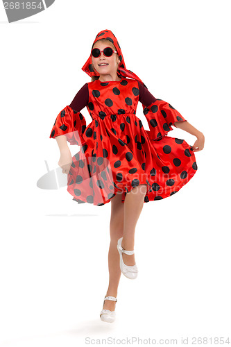 Image of teen girl dancing in a red polka-dot dress with sunglasses