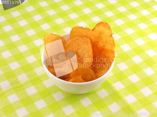 Image of Potato chips falling in the white plate