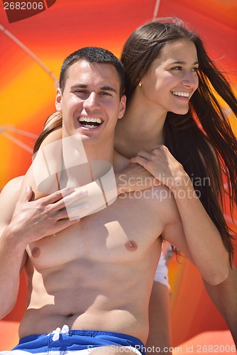 Image of happy couple have fun on the beach