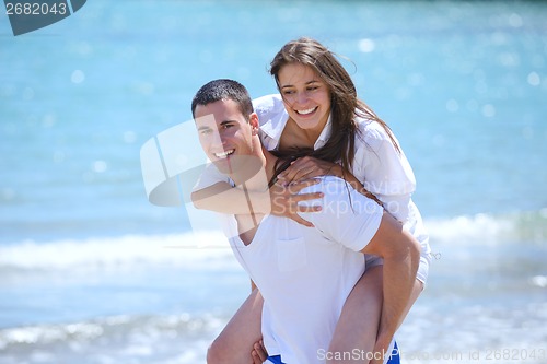 Image of happy couple have fun on the beach