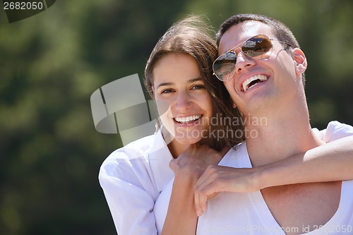 Image of happy couple have fun on the beach